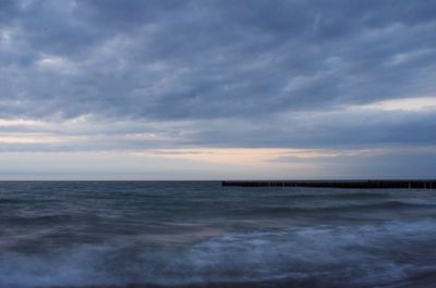 Scenic view of sea against cloudy sky