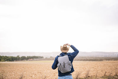 Full length of man standing on field against sky