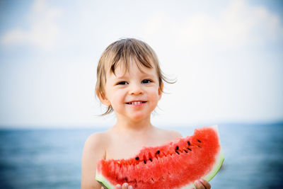 Portrait of happy boy against sea