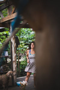 Woman standing by tree