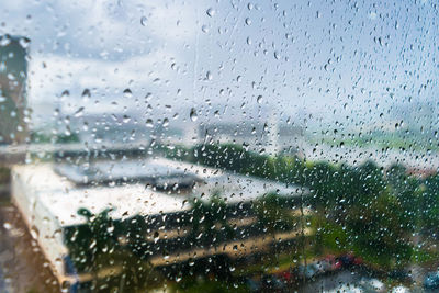 Full frame shot of wet glass window in rainy season