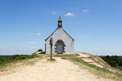 Church tower amidst buildings against sky