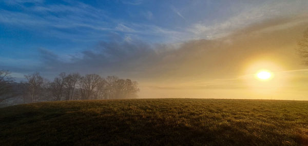 Scenic view of field against sky during sunset