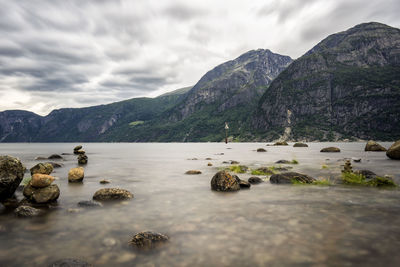 Scenic view of lake and mountains against sky