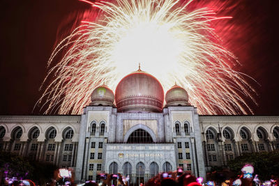 Low angle view of firework display at night