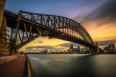 View of bridge over river at sunset