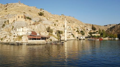 View of buildings in lake with mountain in background