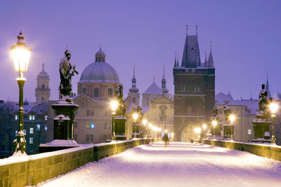 Illuminated church in city at night during winter