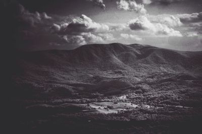 Scenic view of mountains against cloudy sky