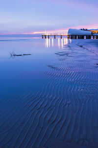 Scenic view of sea against sky at dusk