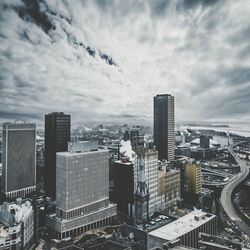 Cityscape against cloudy sky