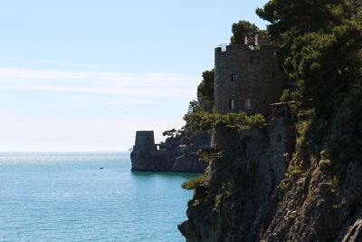 Building by sea against sky