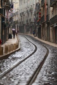 Surface level of tramway amidst buildings in city