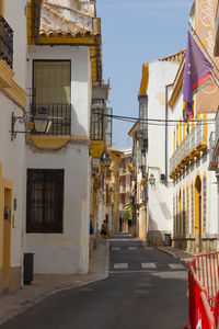 Street amidst buildings in city against clear sky