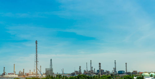 Panoramic view of factory against blue sky