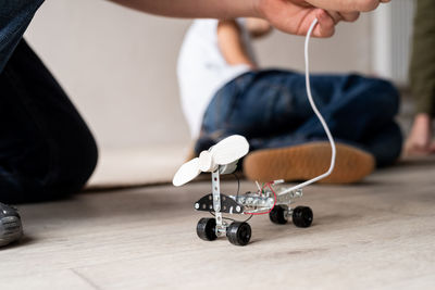 Young boys and having fun constructing robot cars together at the workshop