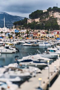 Boats moored at harbor in city