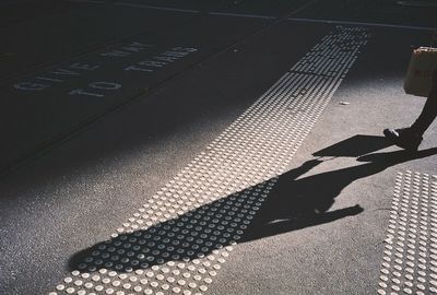 High angle view of shadow on street in city