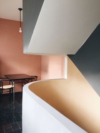 Chairs and table by wall in restaurant