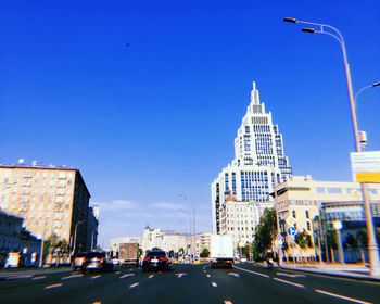 City street and buildings against clear sky