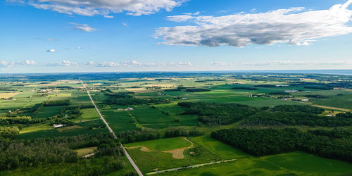 Wisconsin farmlands and roads with lake winnebago shore in the far distance