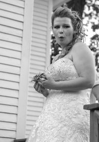 Low angle view of bride puckering lips