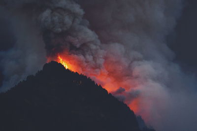 Low angle view of fire against clouds