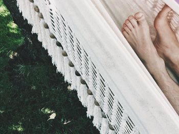 Cropped image of person lying in hammock