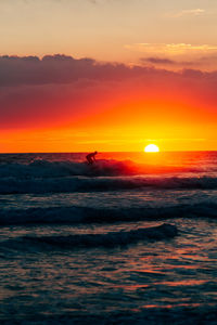 Scenic view of sea against romantic sky at sunset