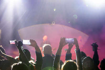 Group of people photographing at music concert