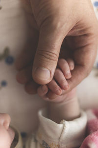 Midsection of child holding hands