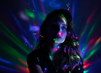 Portrait of woman in illuminated nightclub