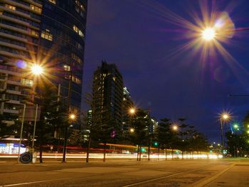 Illuminated city against sky at night