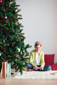 Portrait of smiling girl sitting at home