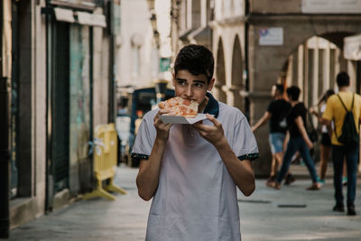 Full length of man eating food outdoors