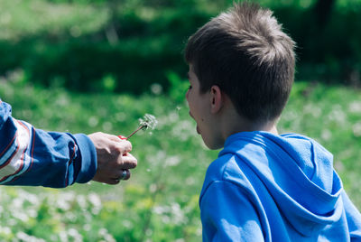 Close-up of boy with grass