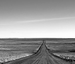 Empty road along countryside landscape