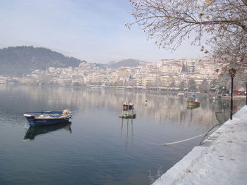 Boats moored on river against sky