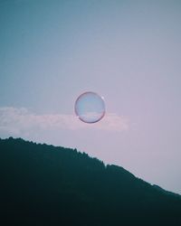 Low angle view of bubbles against sky