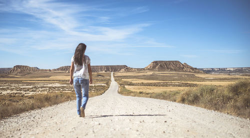 Rear view of man on land against sky