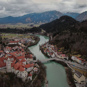 High angle view of townscape by mountains against sky