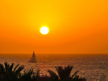 Scenic view of sea against orange sky during sunset