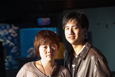 Portrait of siblings standing in aquarium