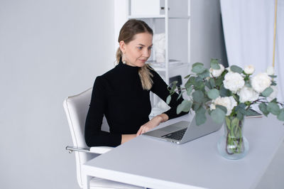 Young woman using laptop at home