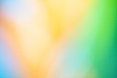 Defocused image of illuminated lights against sky