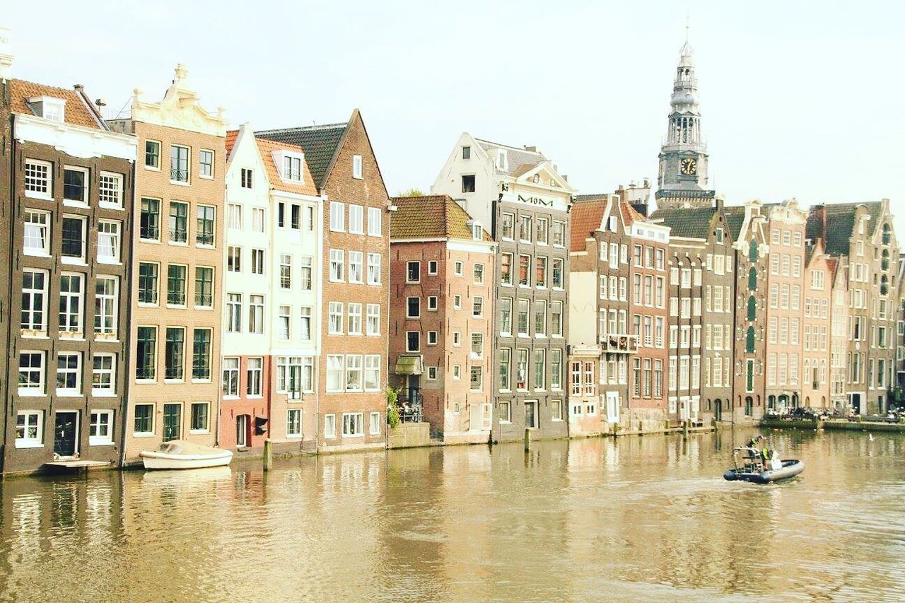 VIEW OF BUILDINGS AGAINST CLOUDY SKY