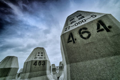 Low angle view of road sign against sky