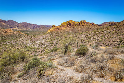 Scenic view of rocky mountains against clear blue sky