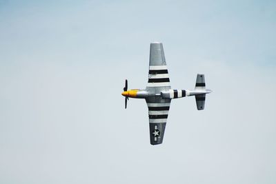 Low angle view of airplane flying against clear sky