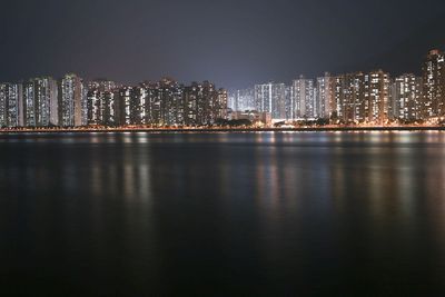 Illuminated city at waterfront